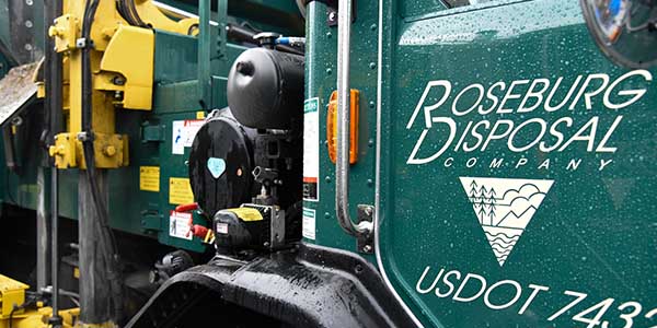 Side of a disposal truck with the Roseburg Disposal branding